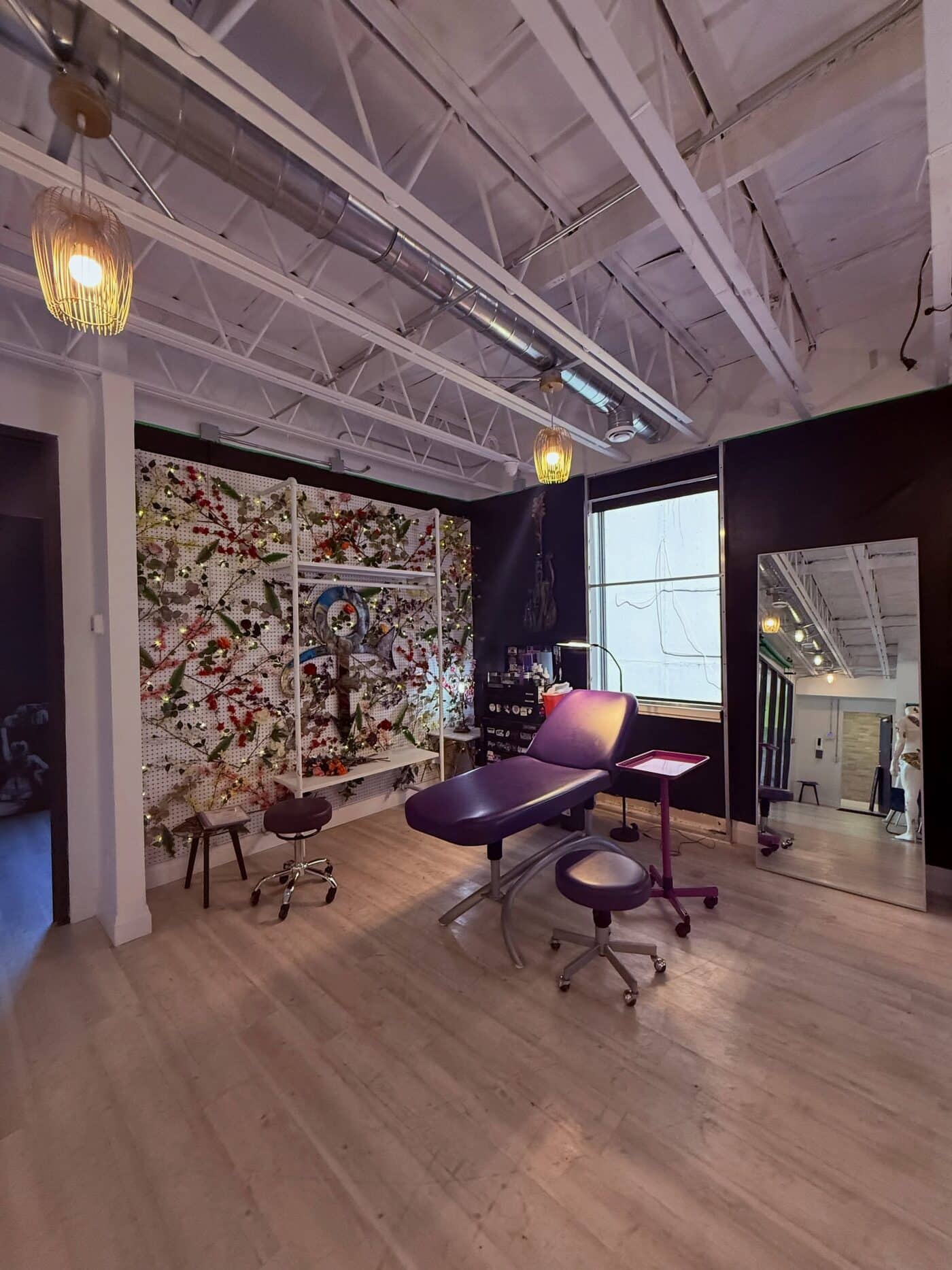 Wide view of the private tattoo room, looking through to the hallway